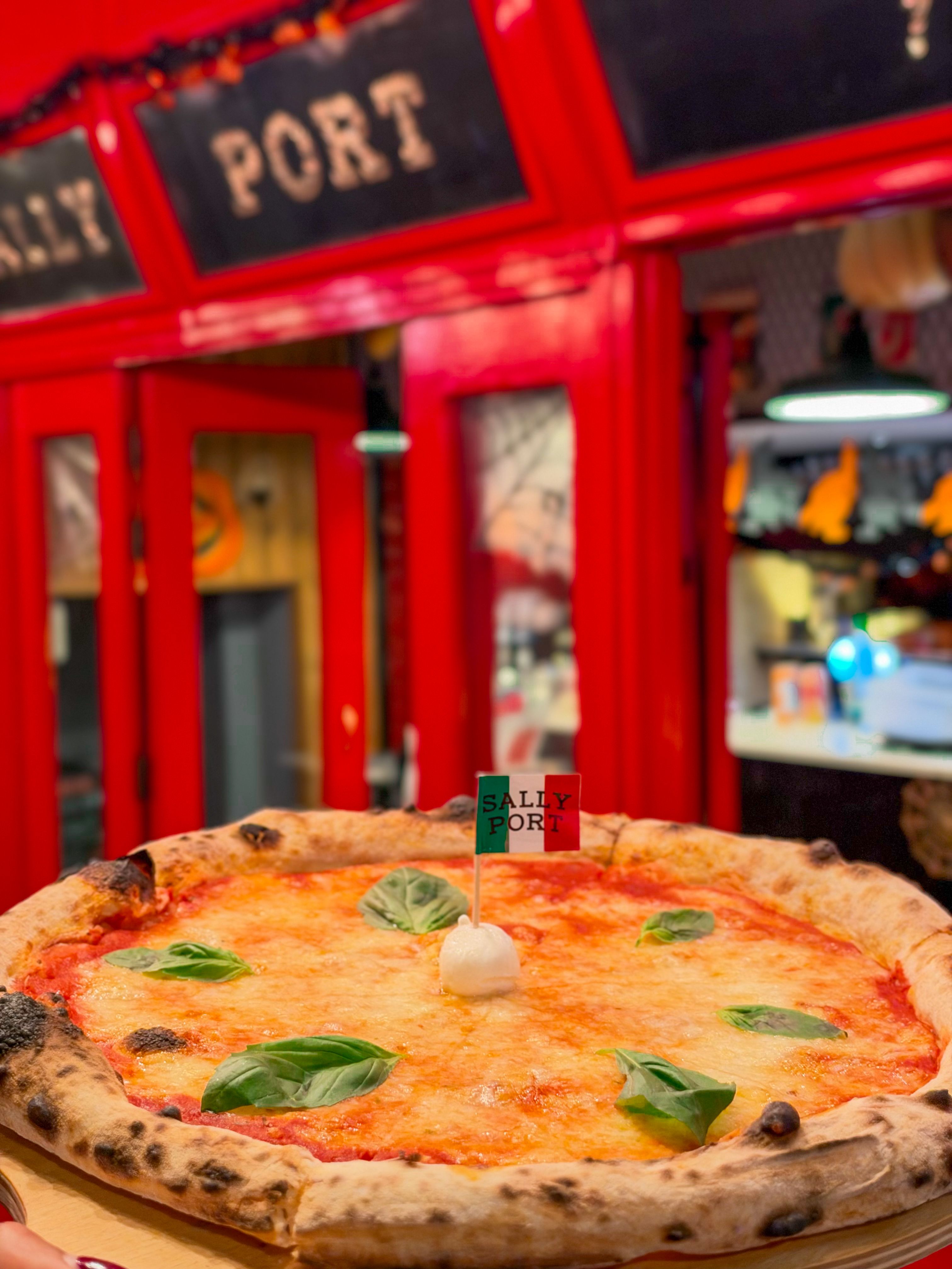 A pizza topped with soft cheese, roe and microgreens, shot from above.